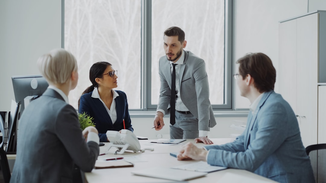 services-hero Businesswoman discussing reports with male and female colleagues sitting at the table in modern office indoors