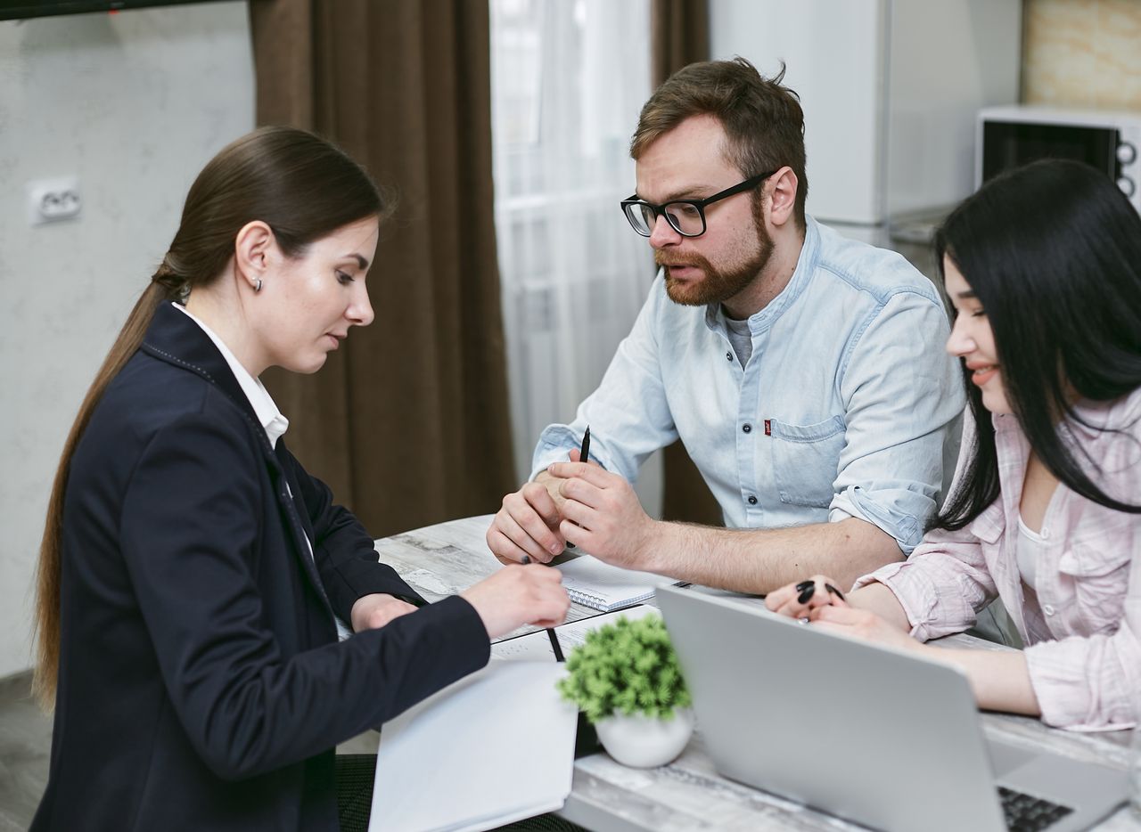 home-hero A couple discusses financial documents with their advisor, highlighting investment strategies.