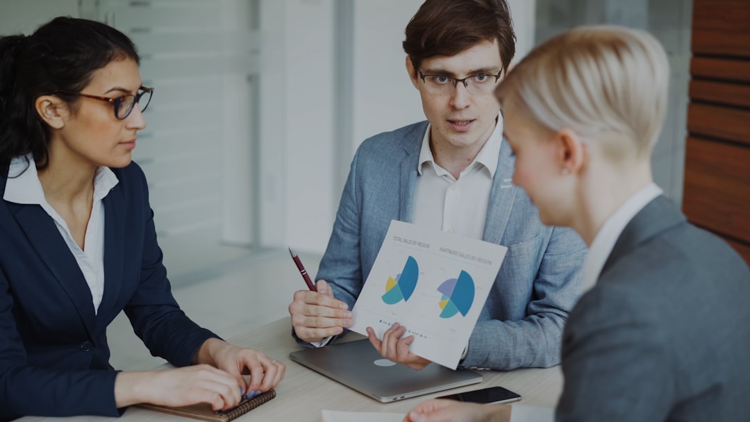 services-02 Angry businessman disappointed with company financial reports and scolding employees sitting at the table in meeting room indoors